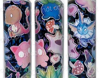 May include: A black and white tumbler with a colorful design featuring cartoon characters, hearts, mushrooms, and plants. The tumbler has the text "Mountain Valley Creations" on the top.