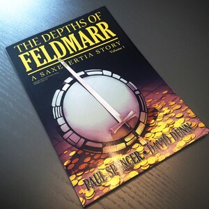 May include: A book titled "The Depths of Feldmar: A Saxertia Story, Volume 1" by Paul Spencer and David Dunn. The cover features a circular design with a sword and gold coins.