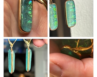 May include: A pair of gold earrings with iridescent green and blue glass stones. The stones are rectangular and have a textured surface. The earrings are approximately 1 inch long.