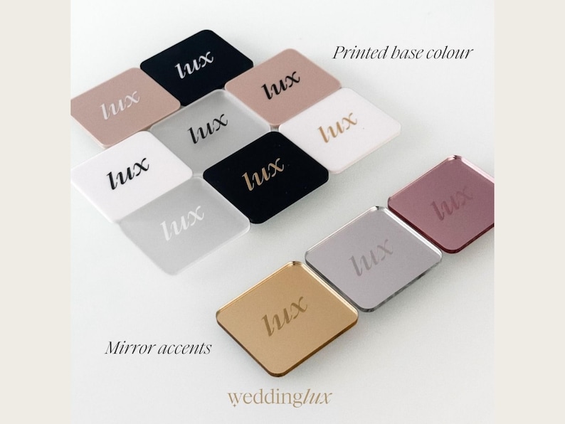 various colored square mirrors with the word "Lux" printed on them, arranged in a grid-like pattern.