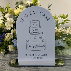 dusky blue dome cake sign with black text and silver mirror stand