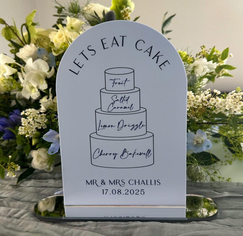 dusky blue dome cake sign with black text and silver mirror stand