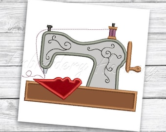 May include: Embroidered design of a vintage sewing machine with a red heart shape under the needle. The machine is on a brown wooden base.