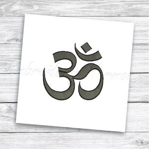 May include: A gray embroidered design of the Om symbol, a sacred sound and syllable in Hinduism and Buddhism.