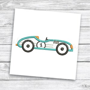 May include: A blue and orange vintage race car with the number 1 on the side. The car has black wheels and a white stripe.
