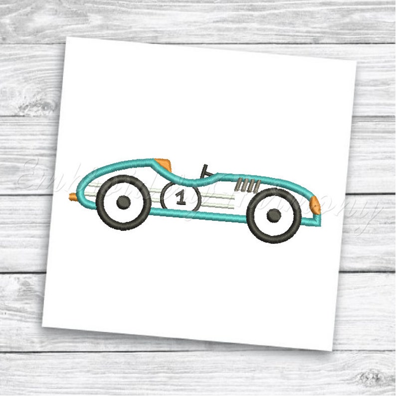 May include: A blue and orange vintage race car with the number 1 on the side. The car has black wheels and a white stripe.