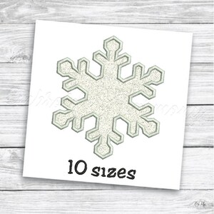 May include: A white snowflake embroidery design with a glittery texture. The design is available in 10 sizes.