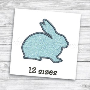 May include: A light blue glitter bunny silhouette embroidery design. The design is available in 12 sizes.