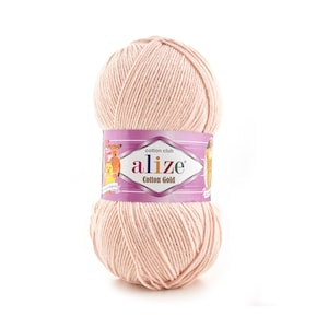 May include: A ball of pale pink cotton yarn with a label that reads "cotton club alize Cotton Gold".