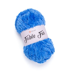 Puede incluir: Un ovillo de hilo YarnArt Fable Fur de color azul brillante. El hilo es suave y esponjoso, perfecto para hacer mantas, bufandas y gorros acogedores.
