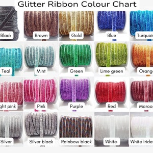 May include: A color chart of glitter ribbon rolls. The ribbon colors are black, brown, gold, blue, turquoise, teal, mint, green, lime green, orange, light pink, pink, purple, red, maroon, silver, silver black, rainbow black, white, and white iridescent.