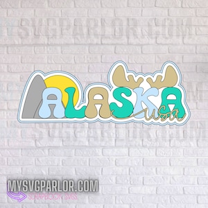 May include: A blue, green, brown, and yellow vinyl sticker with the word "Alaska" and a moose head with antlers. The sticker also includes a mountain and a sun.