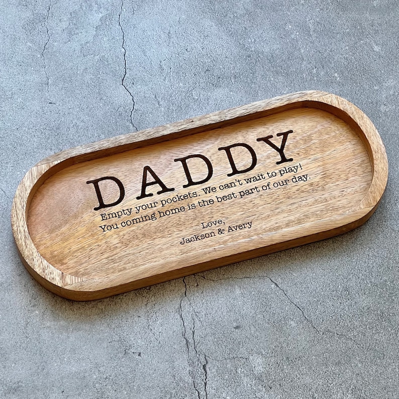 May include: Wooden tray with the words "DADDY, Empty your pockets. We can't wait to play! You coming home is the best part of our day. Love, Jackson & Avery" engraved on it.