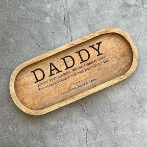 May include: A wooden tray with the words "DADDY, Empty your pockets. We can't wait to play! You coming home is the best part of our day. Love, Levi, Kora, Knox & Lara" engraved on it.