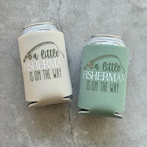May include: Two beige and green can coolers with a fishing rod and the text "a little fisherman is on the way".