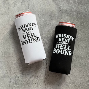 May include: Two black and white can coolers with the text "Whiskey Bent and Veil Bound" and "Whiskey Bent and Hell Bound".