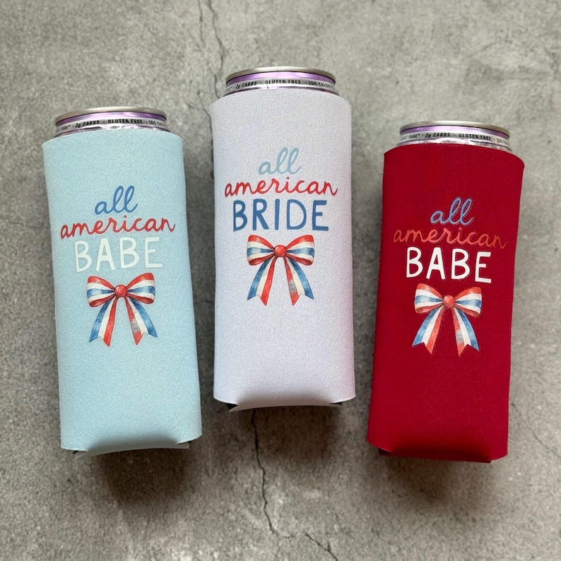 May include: Three can coolers in light blue, white, and red. Each cooler has the text "all american" above a word: "BABE" or "BRIDE". A red, white, and blue bow graphic is below the text. The coolers are designed to keep beverages cold.