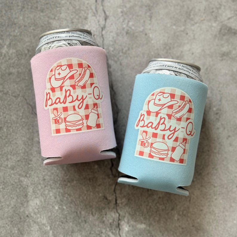 May include: Two beverage can coolers, one pink and one light blue, each with a "Baby-Q" graphic. The graphic includes a cowboy hat, hot dog, baby bottle, and burger on a red and white checkered background.