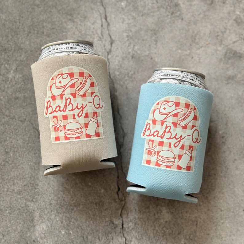 May include: Two beverage can coolers, one tan and one light blue, each featuring a red and white checkered design with the text "Baby-Q" and illustrations of a cowboy hat, hot dog, baby bottle, and burger.