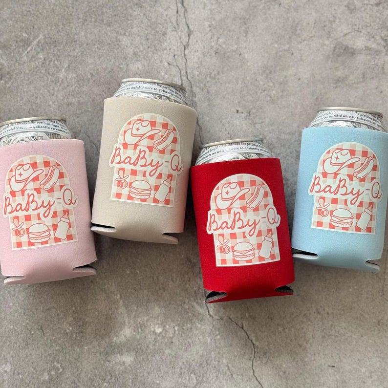 May include: Four beverage can coolers in pink, beige, red, and blue. Each cooler has a white graphic with a cowboy hat, hot dog, burger, and baby bottle, with the text "Baby-Q".