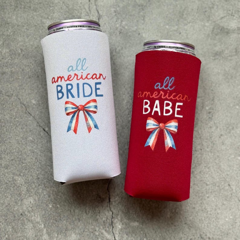 May include: Two can coolers, one white and one red, with patriotic designs. The white cooler says "all american BRIDE" and the red cooler says "all american BABE". Both have a bow in red, white, and blue.