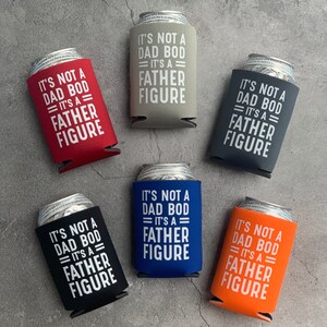 May include: Six different coloured can coolers with the text "It's not a dad bod = It's a father figure" printed in white on each cooler.