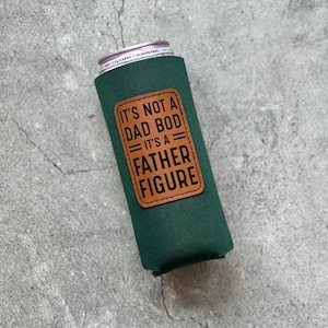 May include: Green can cooler with a brown leather patch that says "It's not a dad bod, it's a father figure."