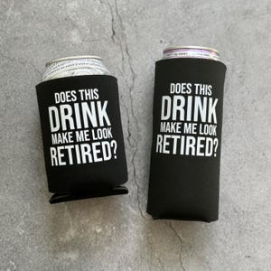 Puede incluir: Dos enfriadores de latas de espuma negra con texto blanco. El texto en el enfriador de la izquierda dice "Does this drink make me look retired?" El texto en el enfriador de la derecha dice "Does this drink make me look retired?"