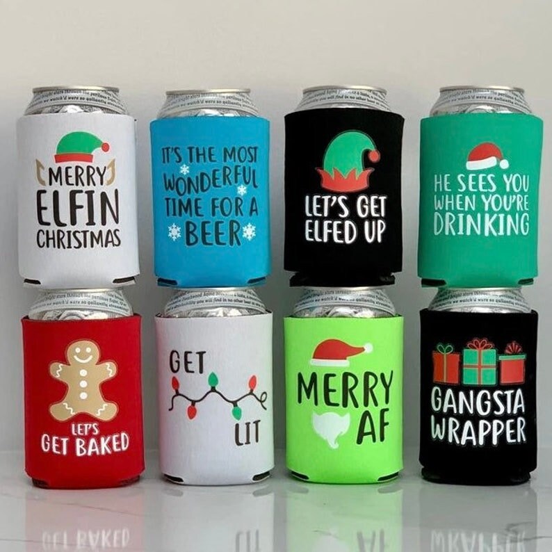 May include: Set of 10 Christmas-themed can coolers with various designs and sayings, including "Merry Elfin Christmas", "It's the most wonderful time for a beer", "Let's get elfed up", "He sees you when you're drinking", "Let's get baked", "Get lit", "Merry AF", and "Gangsta Wrapper".