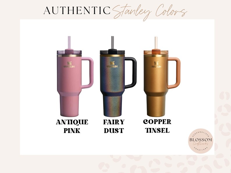May include: Three Stanley tumblers with handles and straws, labeled Authentic Stanley Colors. The colors are Antique Pink, Fairy Dust, which is a dark iridescent finish, and Copper Tinsel. Each tumbler features the Stanley logo on the front.