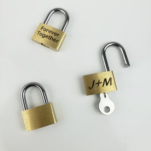 May include: Three gold-toned padlocks with silver keys. One padlock says "Forever Together" and another says "J+M".