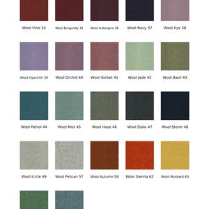 May include: A color chart titled Wool 47 colors displaying twenty-two square fabric swatches in various shades including Vino 34, Burgundy 35, Aubergine 36, Navy 37, Irys 38, Hyacinth 39, Orchid 40, Sorbet 41, Jade 42, Basil 43, Petrol 44, Mist 45, Haze 46, Slate 47, Storm 48, Icicle 49, Pelican 57, Autumn 58, Sienna 62, Mustard 63, Seagrass 64, and Arctic 69.