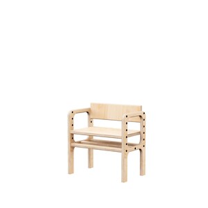 May include: A light-colored wooden chair featuring a flat seat, a rectangular backrest, and two side armrests. The armrests are constructed with vertical panels containing a series of circular holes, and the entire structure is made of plywood.