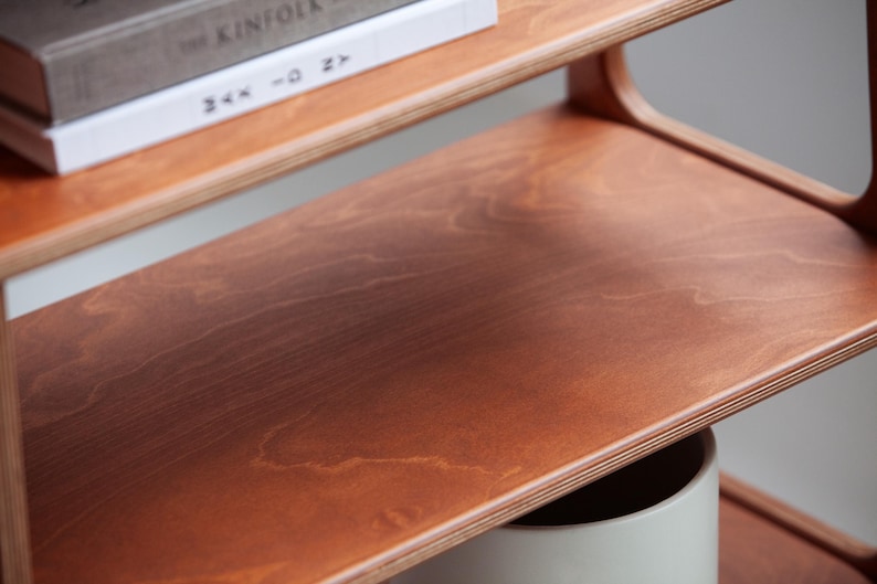 Close-up of a Finnish birch plywood shelf with a soft rounded edge and smooth hand-finished surface, part of the mid century modern bookcase.