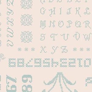 May include: A light pink background with a blue cross-stitch pattern of letters, numbers, and designs. The letters are in a cursive font and include the alphabet from A to Z. The numbers are from 0 to 9. The designs include a flower, a star, and a geometric pattern.
