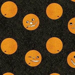May include: A repeating pattern of orange circles with various carved faces, like jack-o'-lanterns, on a dark, textured background. Some circles are plain. The design evokes a Halloween theme.