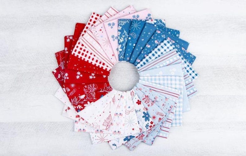 May include: A circular arrangement of folded fabric squares featuring a variety of patterns in red, white, and blue. The collection includes gingham, stripes, and floral motifs, showcasing a cohesive color palette of patriotic shades.