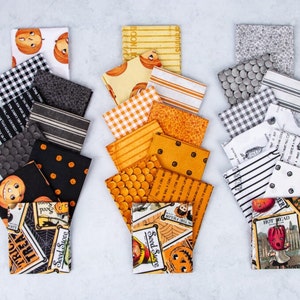 May include: A set of 30 fabric squares featuring a Halloween theme. The squares are in various patterns and colors, including black, white, orange, and yellow. Some squares feature pumpkins, ghosts, and other Halloween imagery. The text "Seed Store" and "Trick or Treat" are visible on some of the squares.