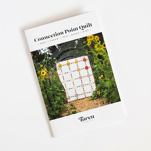 May include: A quilt pattern booklet with a colorful quilt design on the cover. The quilt is made of white fabric with circles of different colors and sizes. The text on the cover reads "Connection Point Quilt | Baby | Throw | Twin | Queen | King | Taren Studios".