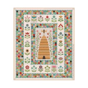 May include: A colorful quilt featuring a central beehive design surrounded by floral and geometric patterns. The quilt showcases a variety of flowers and a bee, with a patchwork border in shades of green, pink, and blue.