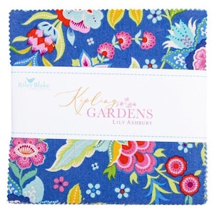 May include: A stack of square fabric pieces featuring a blue background with a colorful floral pattern in pink, yellow, and light blue. A white paper band wraps around the center with the text Riley Blake, Kipling Gardens, and Lily Ashbury.
