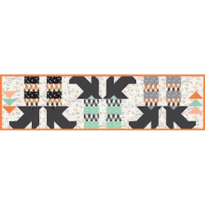 May include: A rectangular table runner featuring a repeating pattern of dark gray witch boots, checkered columns in black, white, orange, and mint green, and a background print of small skulls, stars, and moons, all bordered by a thin orange frame.