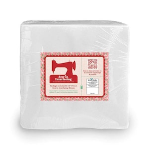 May include: A package of 50 precut 14-inch Sew-in Interfacing Sheets by Lori Holt of Bee in my Bonnet. The package is wrapped in clear plastic and has a red and white label with a sewing machine graphic and the text "Sew-in Interfacing".