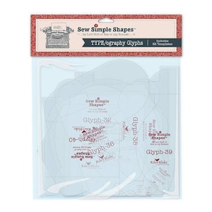 May include: A package of clear sewing templates with various shapes and the text "Sew Simple Shapes" and "TYPE/ography Glyphs". The package has a red and white decorative border with a vintage typewriter illustration.