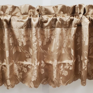 May include: A gold valance with a floral pattern. The valance has a scalloped edge and is made of a silky fabric.
