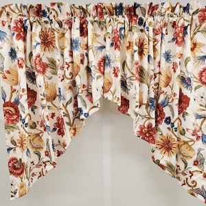 May include: A white valance with a floral pattern in shades of red, yellow, blue, and green. The valance has a scalloped edge and is made of a lightweight fabric.