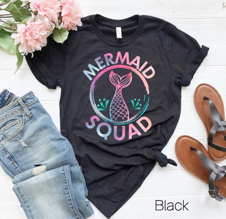 May include: Black t-shirt with a mermaid tail graphic and the text "Mermaid Squad" in a rainbow watercolor style.