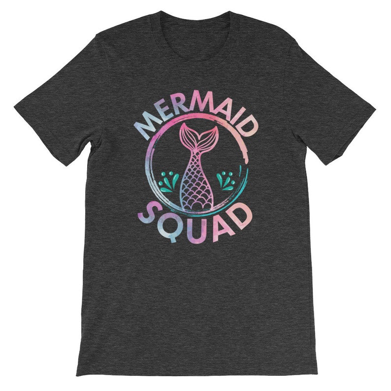 May include: A dark heather grey t-shirt with a graphic of a mermaid tail inside a circle with the text "Mermaid Squad".
