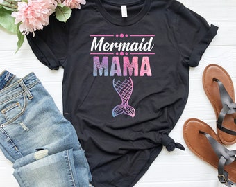 May include: Black t-shirt with a pink and blue mermaid tail graphic and the text "Mermaid Mama" in pink letters.