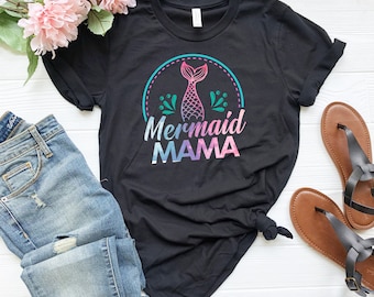 May include: Black t-shirt with a mermaid tail graphic and the text "Mermaid Mama" in a rainbow ombre design.